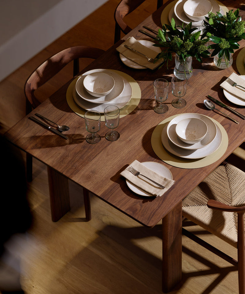 Dining table with four sets set for a dinner party