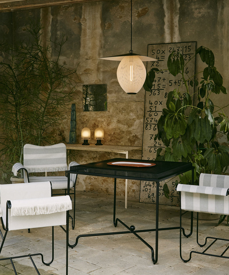 Outdoor pendant light hanging above a table