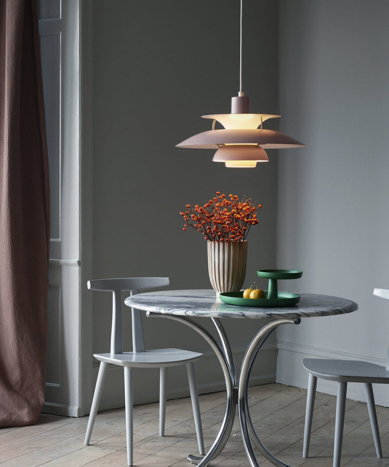 PH 5 pendant in hues of pink above a dining table