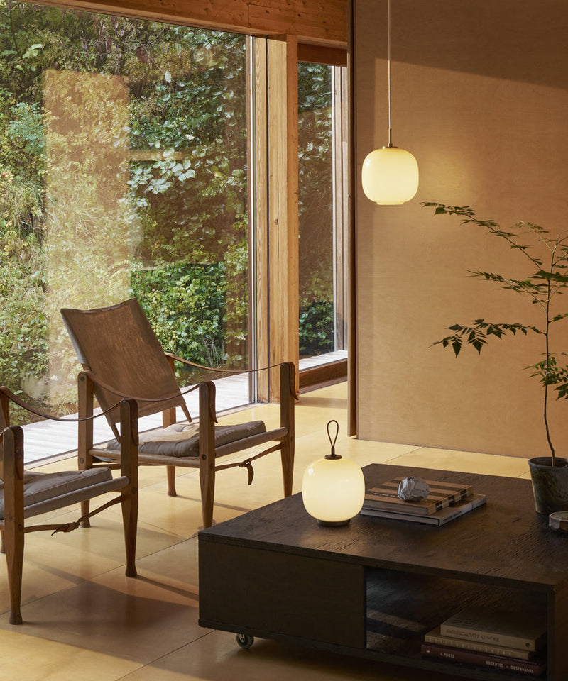 Image of a modern living room featuring the VL 45 pendant light and portable lamp
