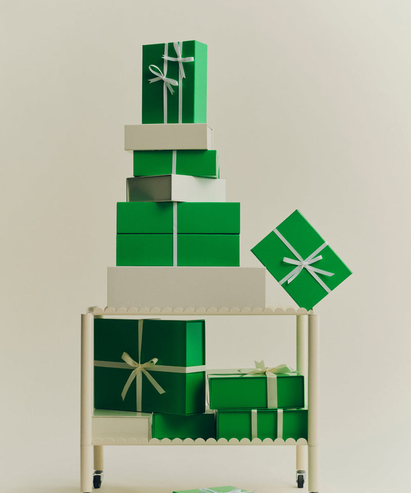 A tower of gift wrapped parcels on a trolley