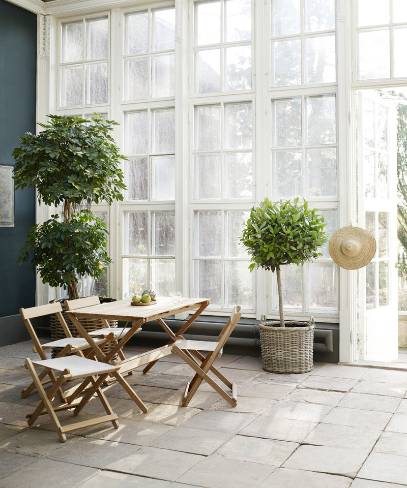 The BM wooden furniture collection in a garden room featuring a table and 4 chairs