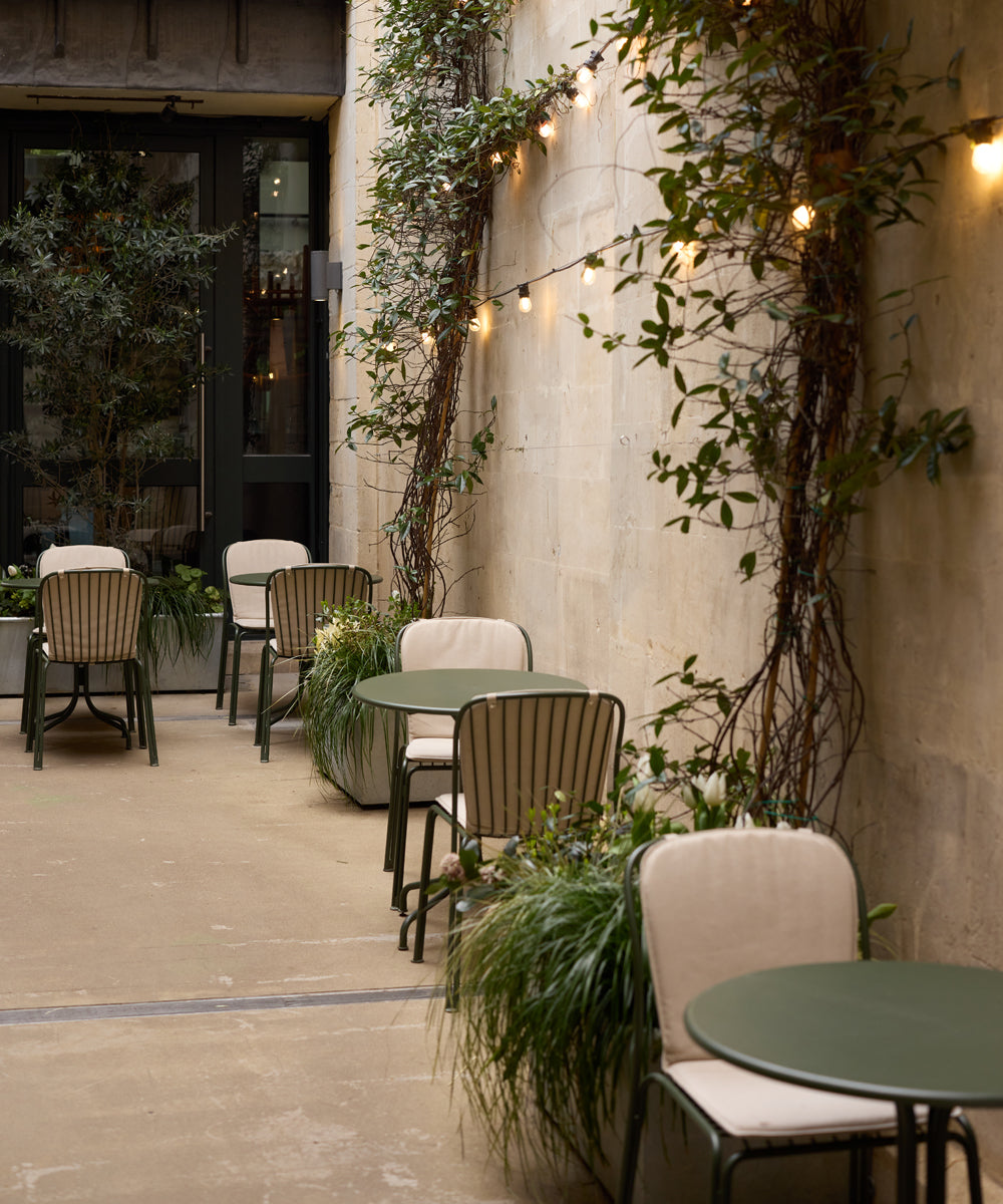 A collection of Thorvald outdoor furniture in the courtyard outside a coffee shop