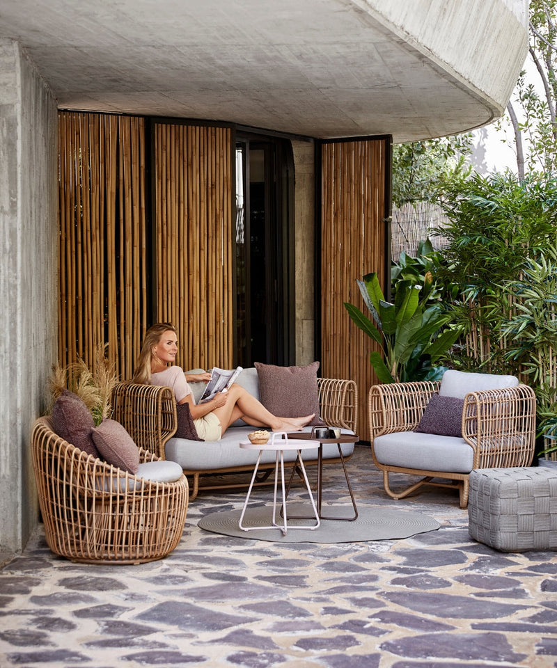 The Cane-line Nest garden furniture collection on a patio
