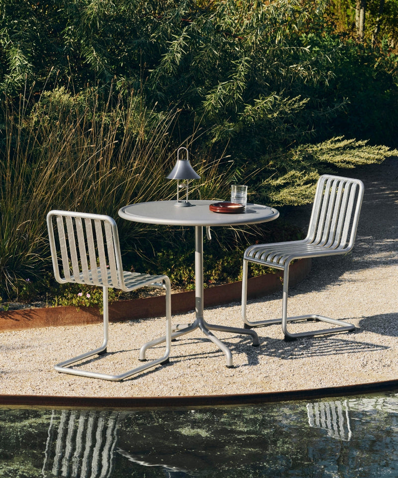 Two HAY Cantilever chairs in hot galvanised around a small round table