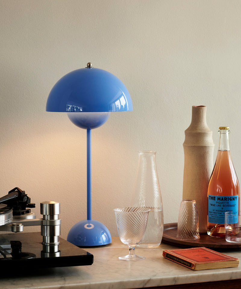 Light blue VP3 Flowerpot table lamp next to a record player 
