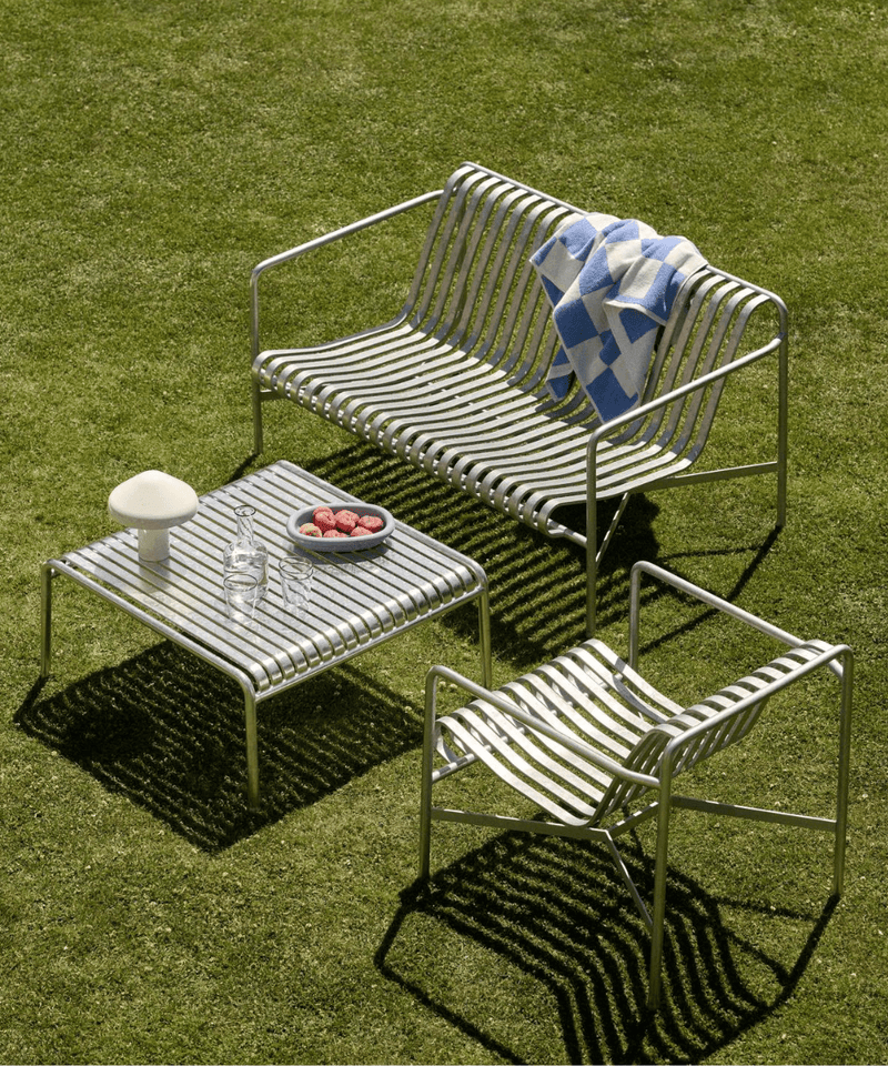 HAY Palissade lounge chair, sofa and low table in galvanised steel, set on a lawn