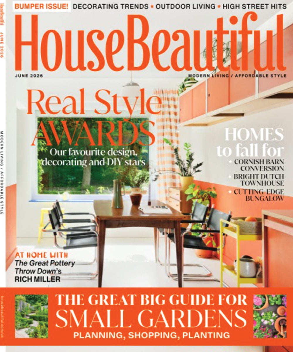 House Beautiful magazine cover featuring a bright modern kitchen-dining space with coral cabinetry and bold orange typography