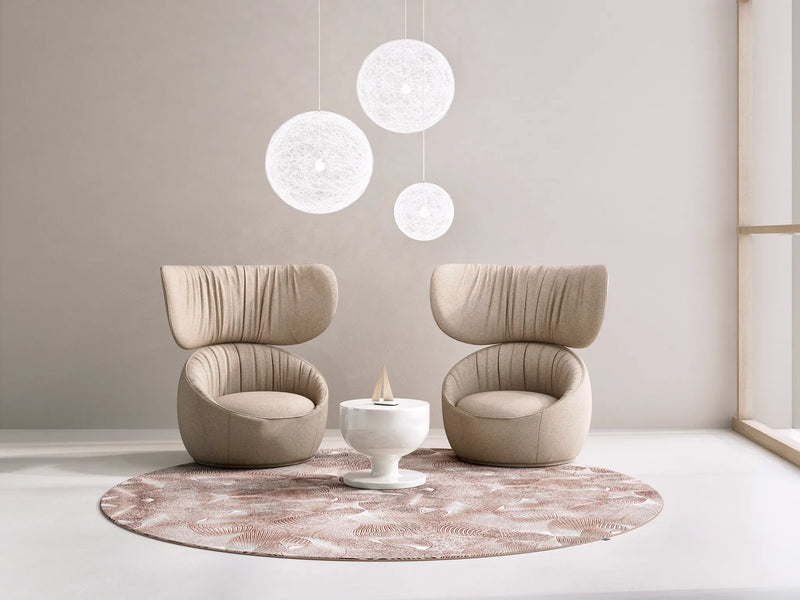 An image featuring 2 chairs & 3 lantern lights  and a pink abstract art rug