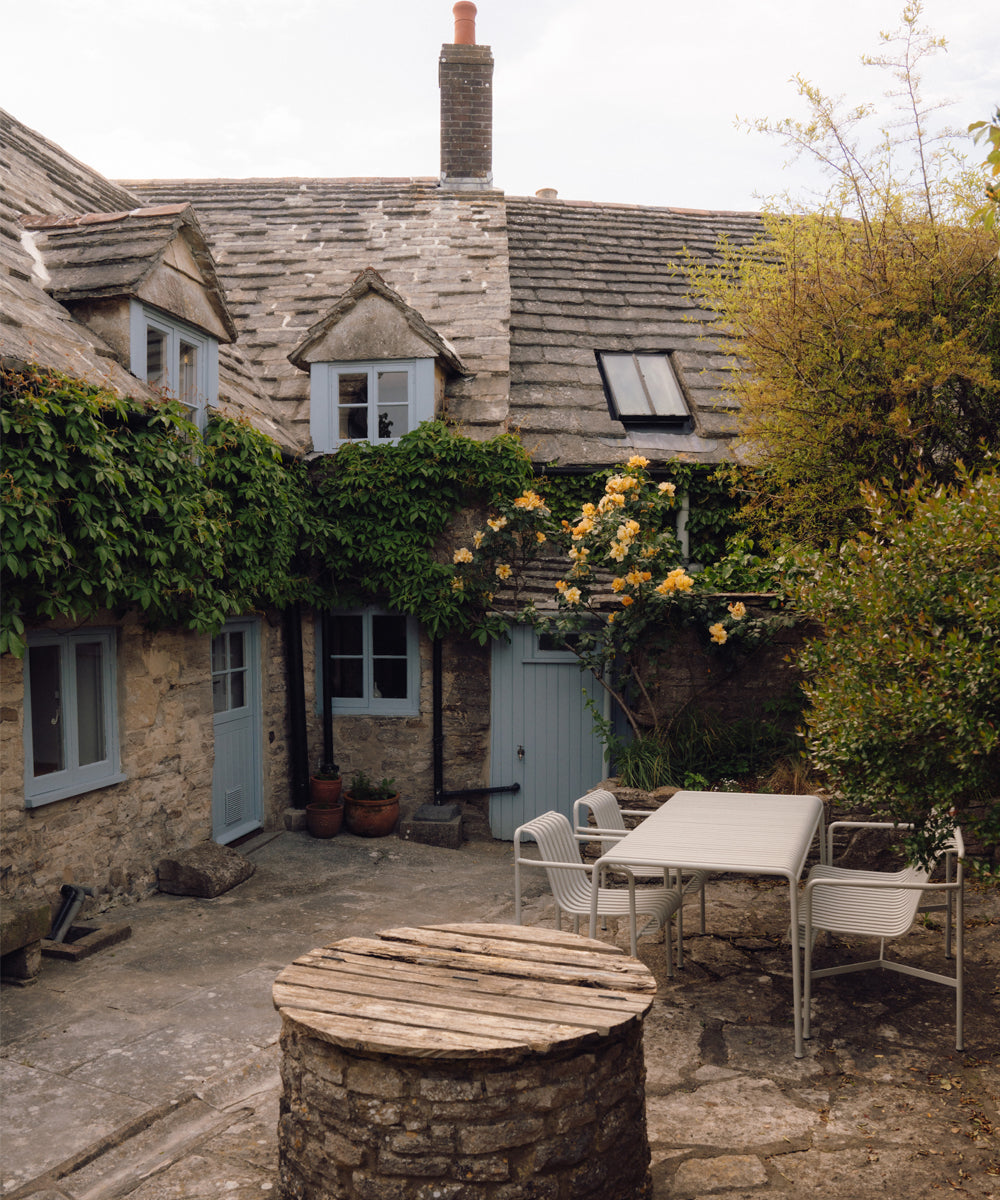 Exterior view of the cottage showing the palissade garden furniture
